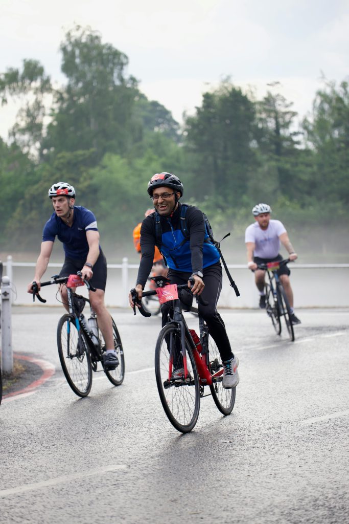 pexels-photo-17272197-17272197 Group of cyclists riding on road during a charity bike event on a misty day.